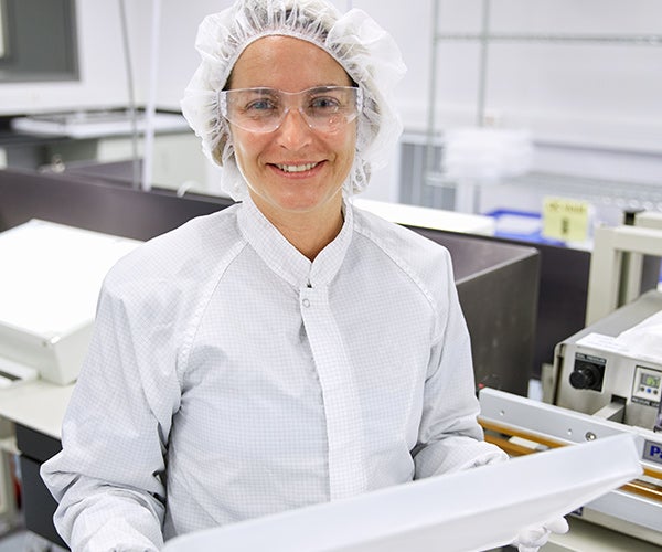 Technician holding LYOGUARD Tray in cleanroom