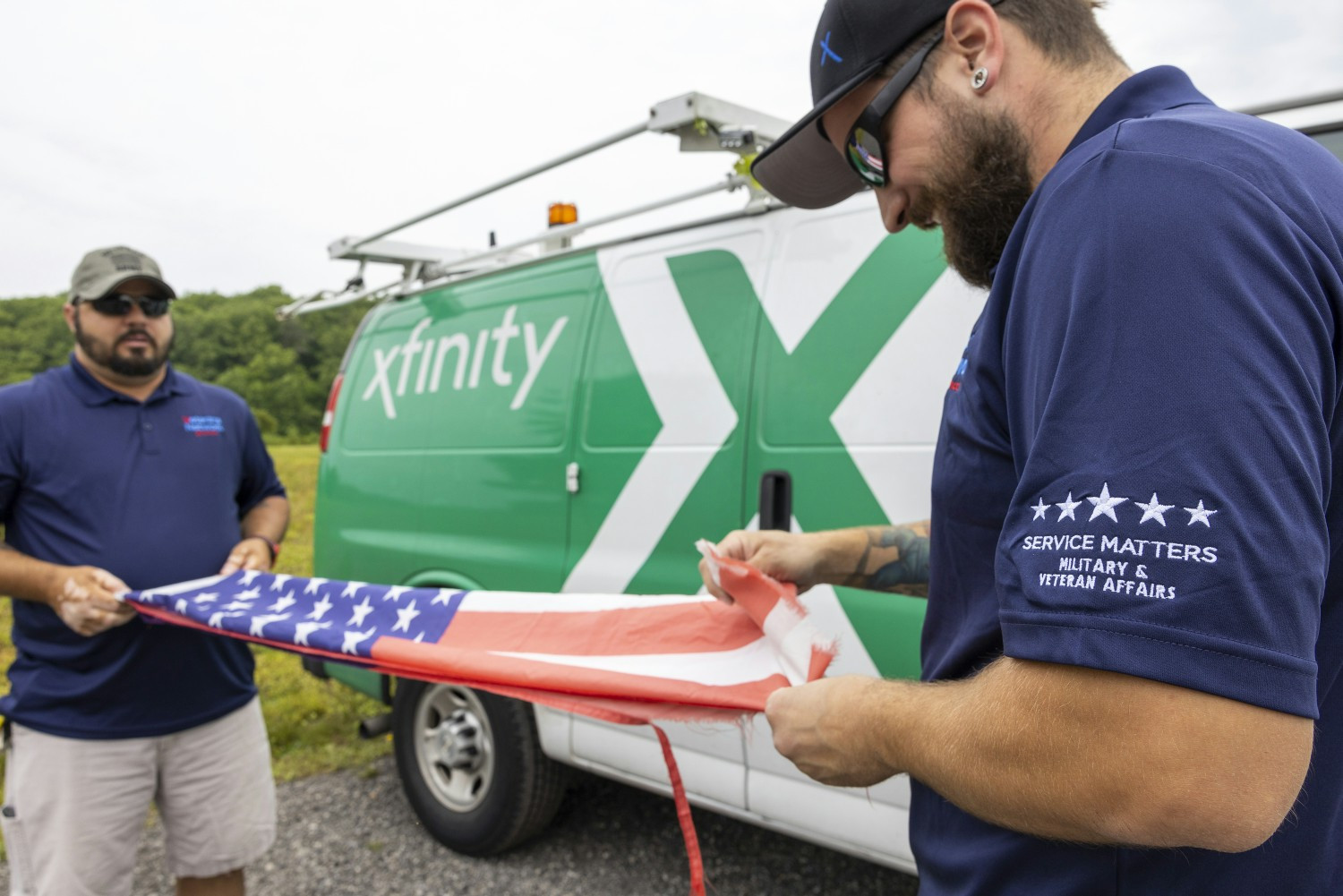 Comcast Flag Ambassadors replace weathered flags as part of Operation Old Glory