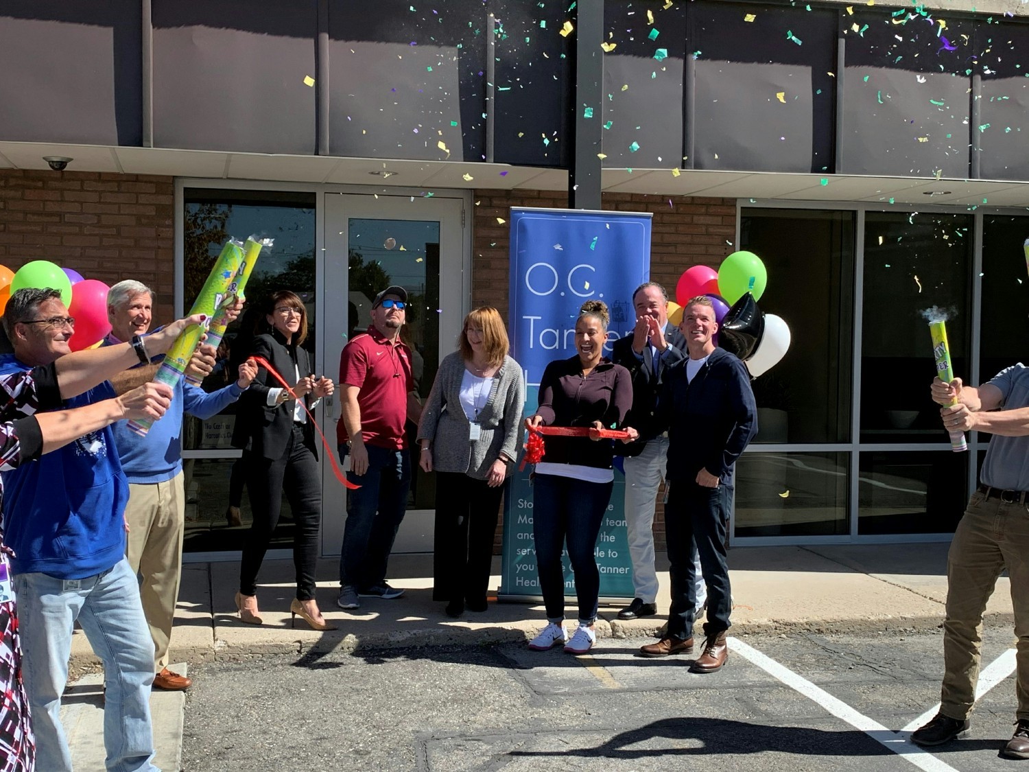 Employees celebrate the ribbon cutting of the onsite O.C. Tanner Health Center.