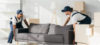 Movers loading wrapped furniture into moving truck