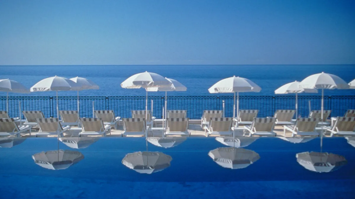 White umbrellas by a pool.