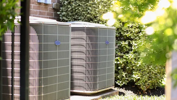 Two air conditioning units outside a building.