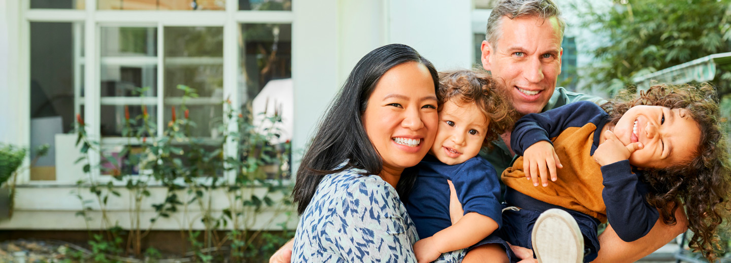 Photo of family in front of house