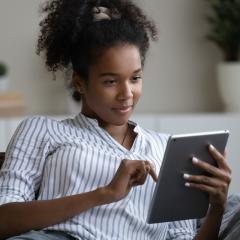 Woman reading tablet. Image credit: fizkes via Shutterstock