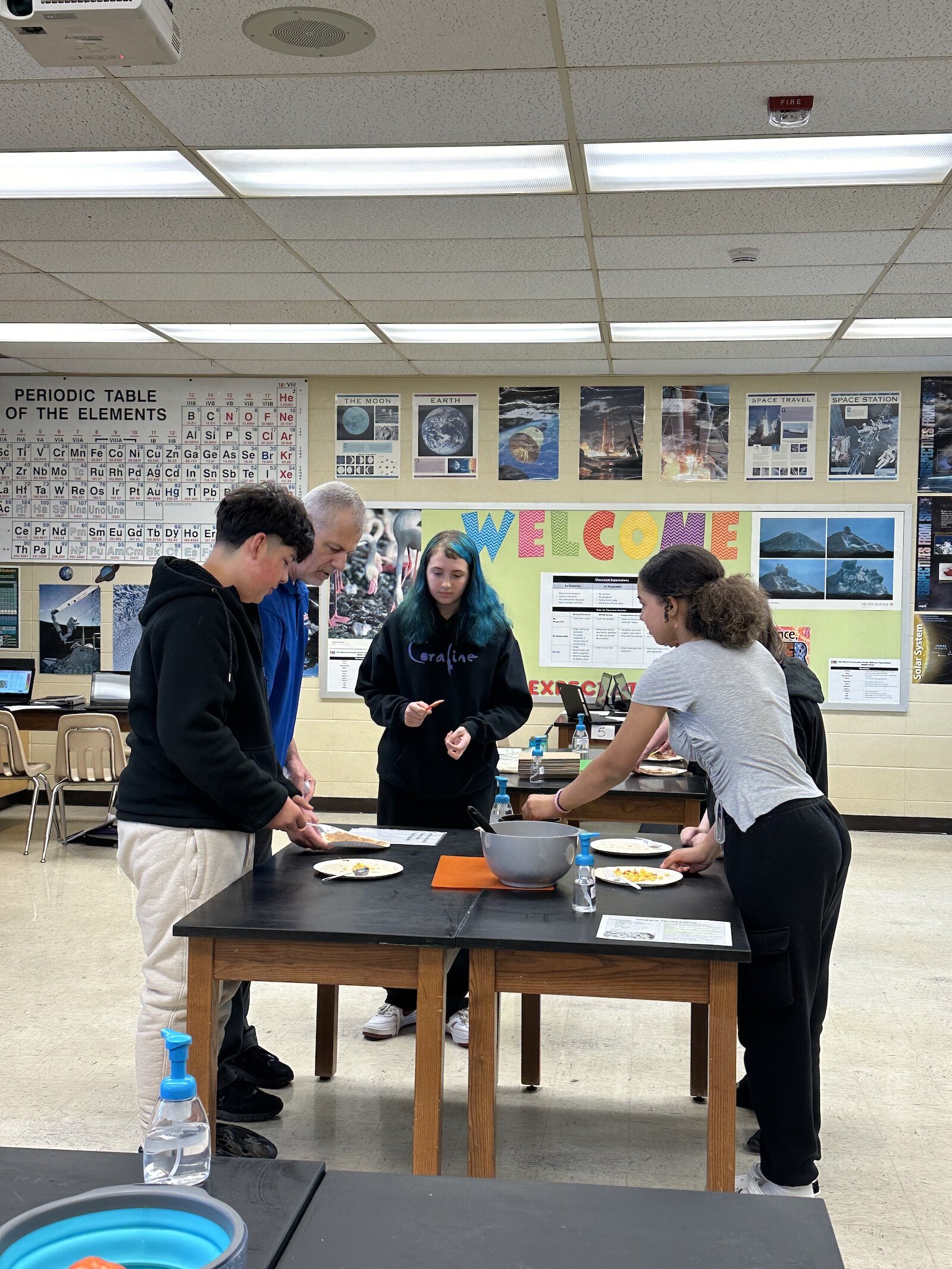 Students in Mr. Larsen's class add toppings to their quesadillas as part of the Cooking in the Classroom program.