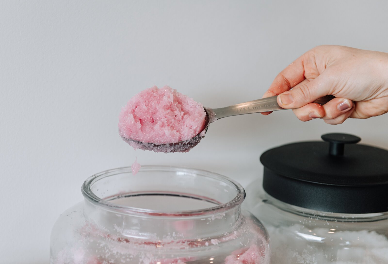 Bottle Green Refillery Owner Corinna Shoemaker scoops an exfoliating acai scrub.