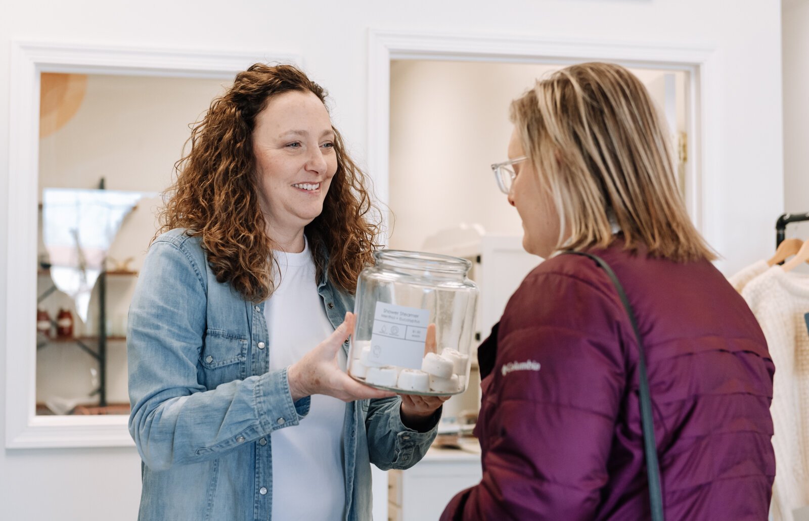 Heather Eracleous, owner of Vessel Refillery FW, helps a customer pick out mental + eucalyptus shower steamers.