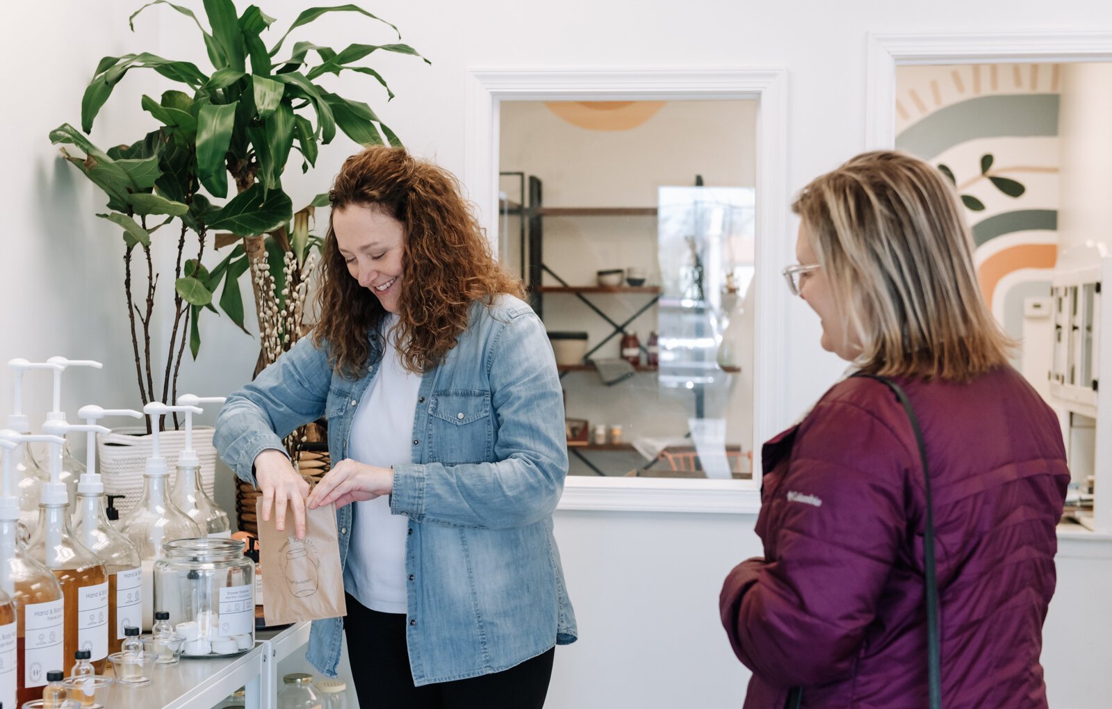 Heather Eracleous, owner of Vessel Refillery FW, helps a customer pick out mental + eucalyptus shower steamers.