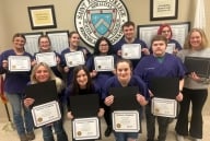 A group of veterinary assistant program students at Saint Joseph's College pose with their certificates.