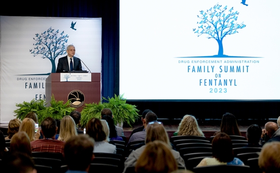 Attorney General Merrick B. Garland delivers remarks from a podium at the Drug Enforcement Administration.