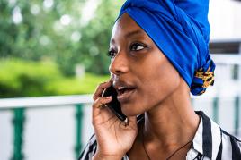 woman speaking on the phone and looking off into the distance