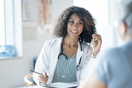 Medical researcher speaking with a patient