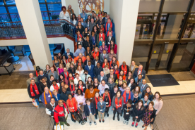 Advocates standing on stairs smiling up at the camera.