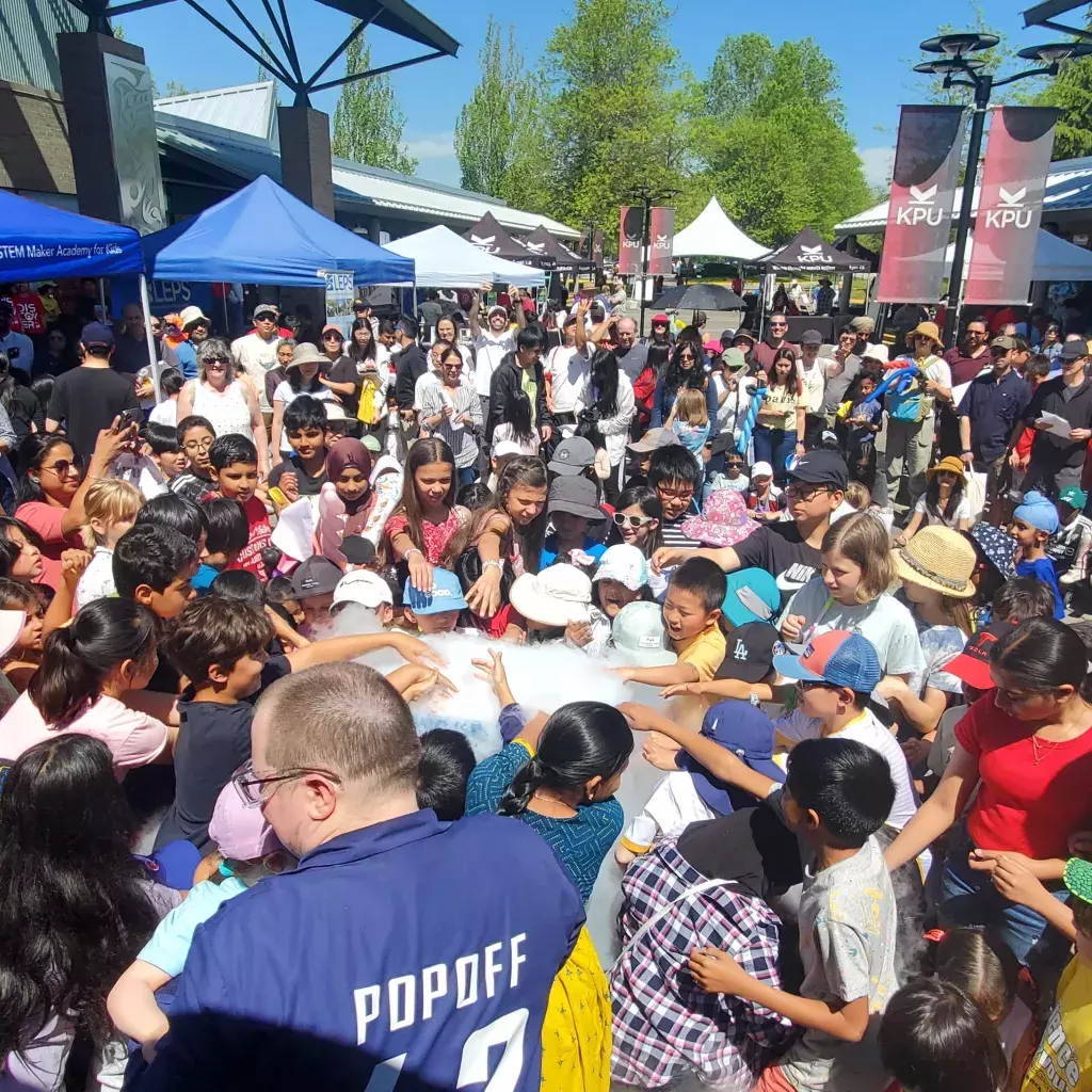 Children crowding around a frothing science display at KPU Langley