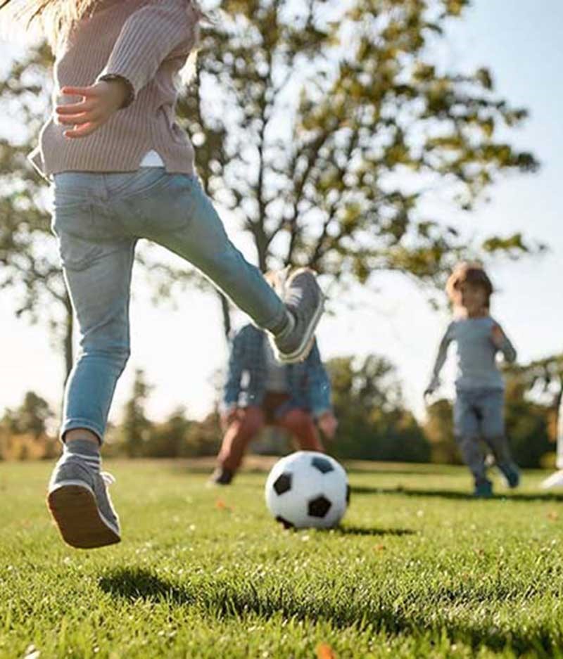 girl kicking soccer ball