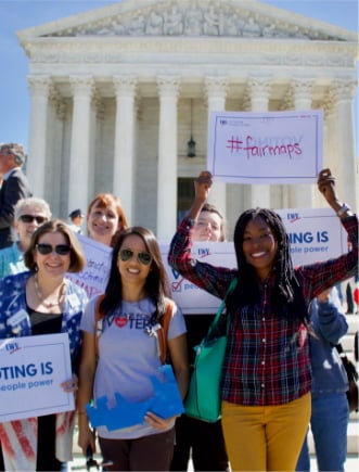 Group of women holding #fairmaps protest signs