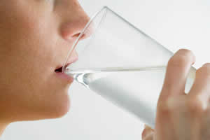 Person drinking a glass of water