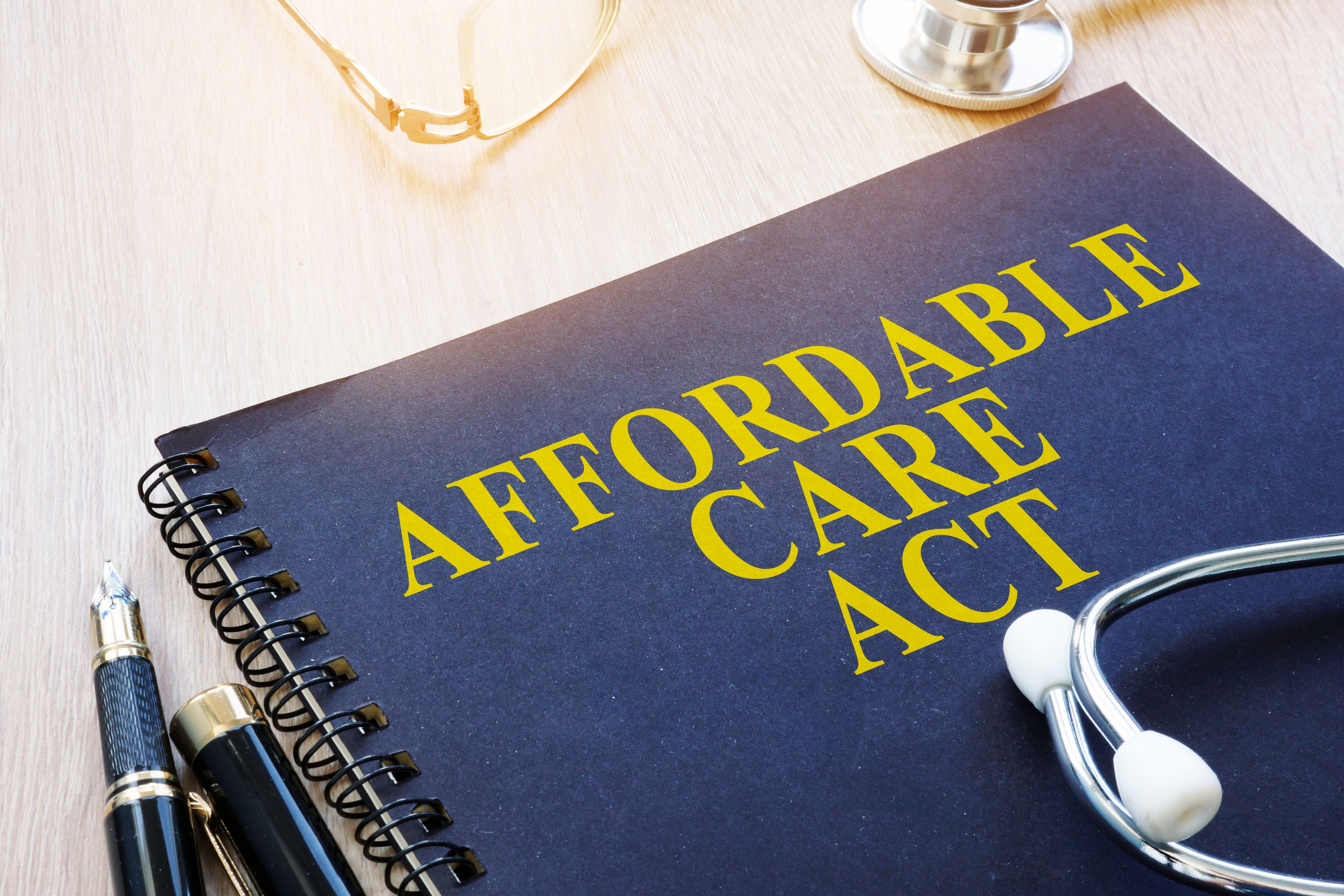 Blue binder with Affordable Care Act written on it | Image credit: ©Vitalii Vodolazskyi stock.adobe.com