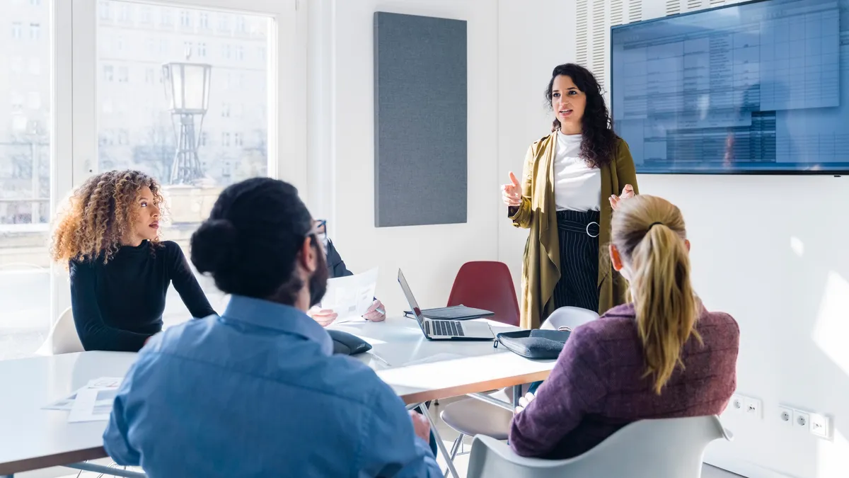 Business person addressing colleagues at a corporate business meeting