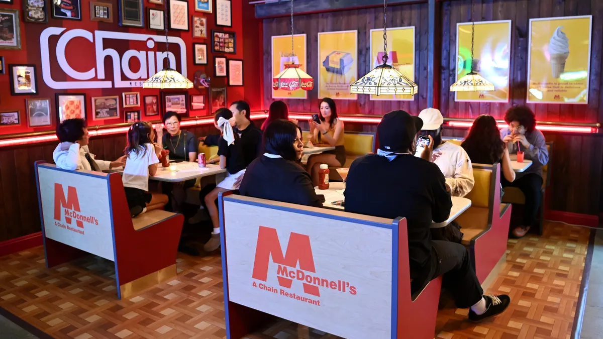 Consumers dine at a McDonnell's experience at Chain