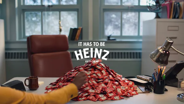 A pile of Heinz ketchup packets on a desk