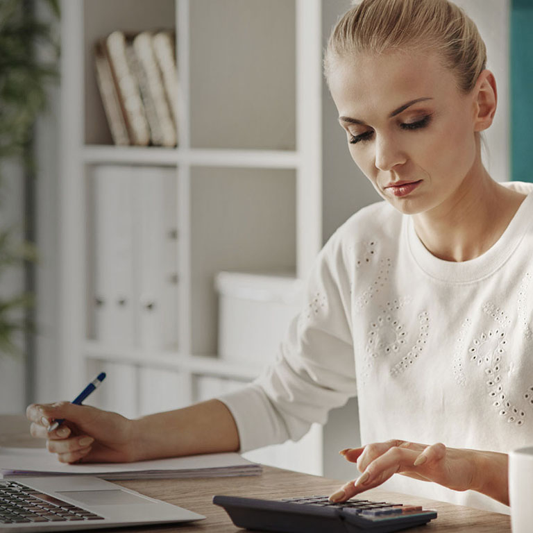 Concentrated woman budgeting at office