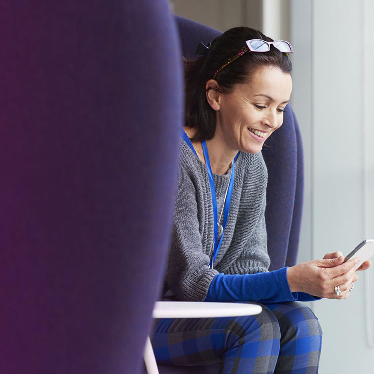 Woman smiling at smartphone