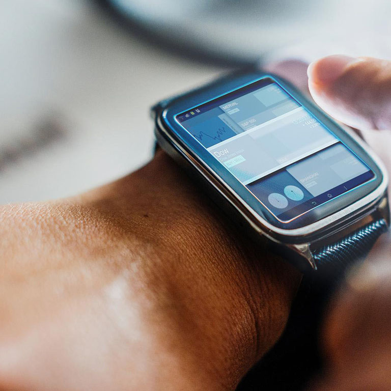 Male finger about to touch the screen on a smartwatch