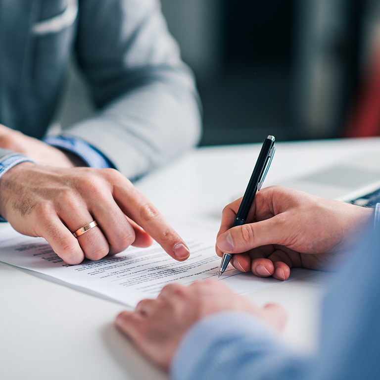 Businessmen hand's pointing where to sign a contract, legal papers or application form. 