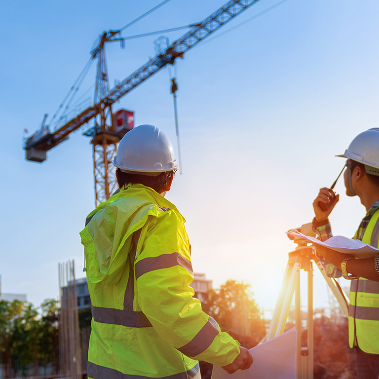 Construction engineers discussion with architects at construction site or building site of highrise building with Surveying for making contour plans is a graphical representation of the lay in land.