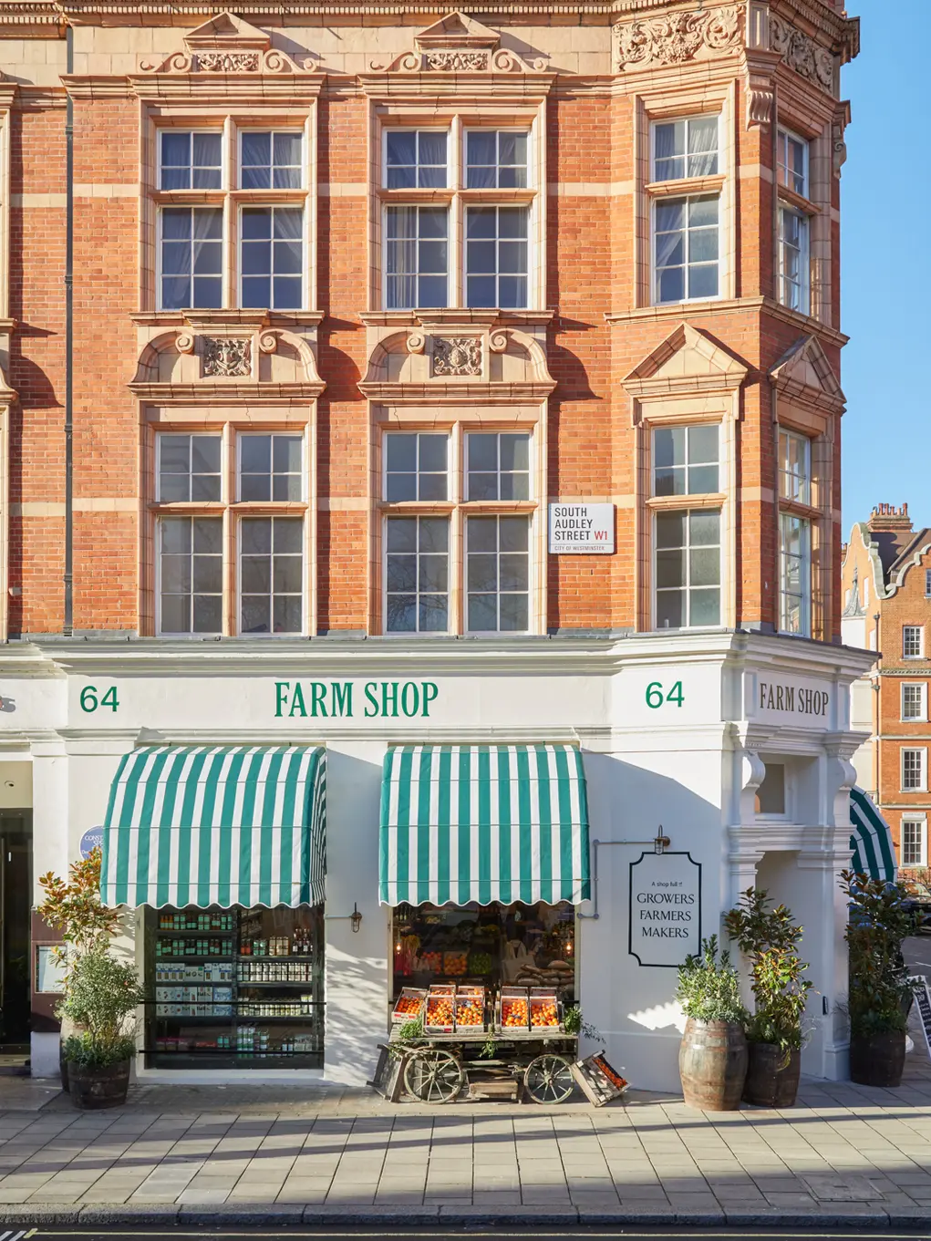 The front of Farm Shop with its green and white striped awning