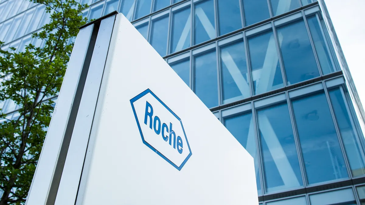 A Roche logo is seen on the side of a building.