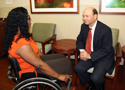 Woman in wheelchair talking to man