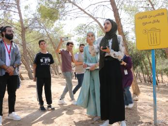 Several people standing on a hiking trail