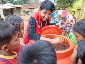 A group of young people receive clean water.