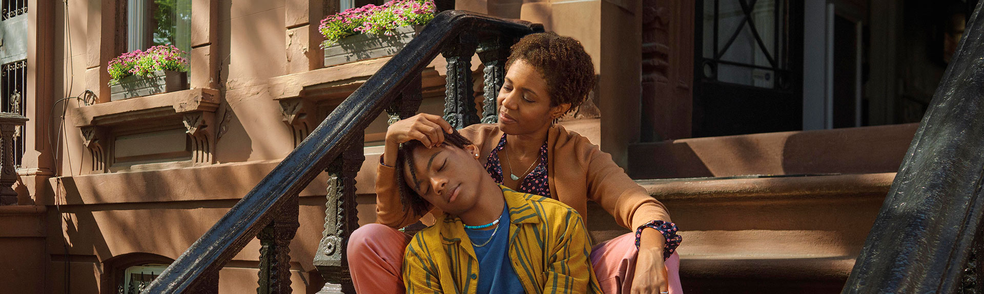 mother with child sitting on stoop