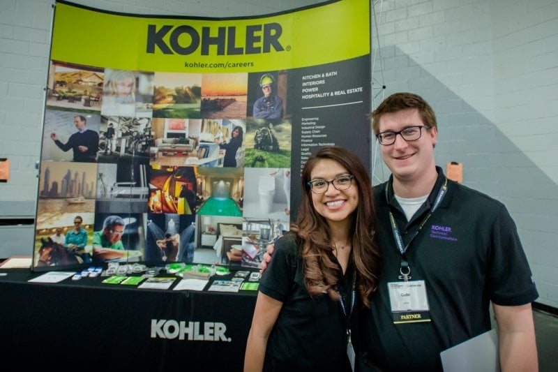 Two corporate representatives at their Career Fair table.