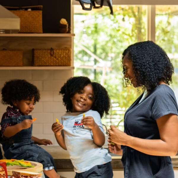 family in kitchen cooking a snack