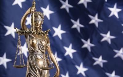 lady justice in front of American flag