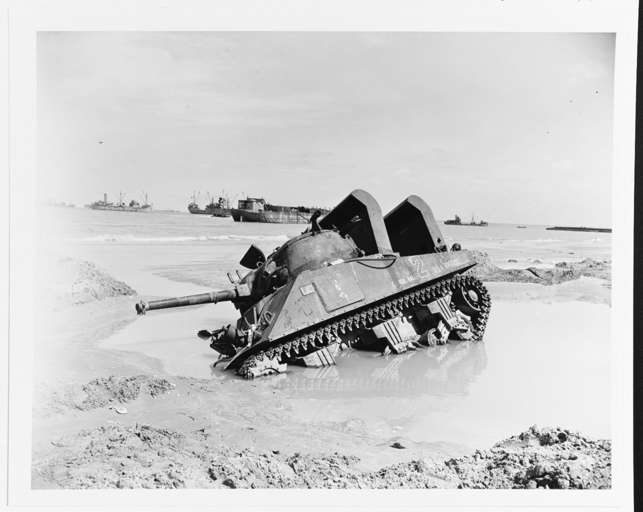 Mired M4 Sherman tank on a Normandy invasion beach, 12 June 1944