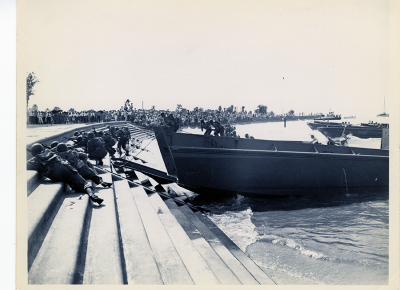 Servicemen climbing Lake Pontchartrain concrete beach from LCPLs