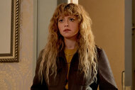 Natasha Lyonne, as Charlie Cale in Poker Face, standing in a doorway.