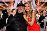 Richard Goodall and Heidi Klum embrace onstage