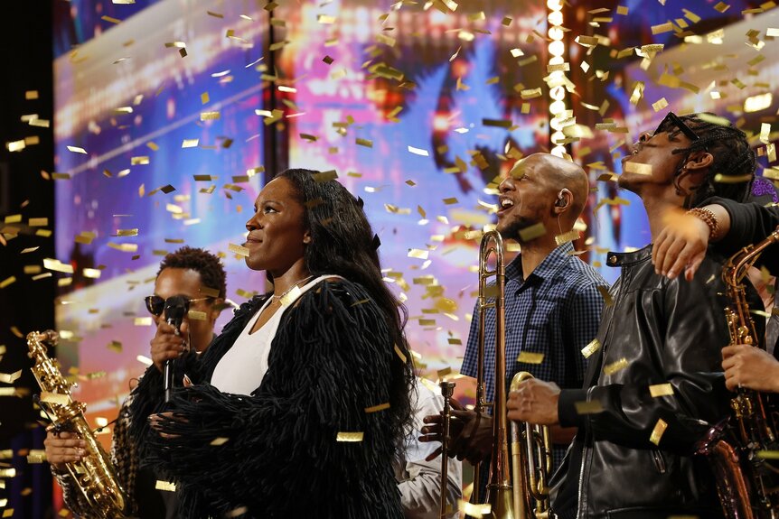 Golden confetti falls upon Liv Warfield on America's Got Talent Episode 1902.