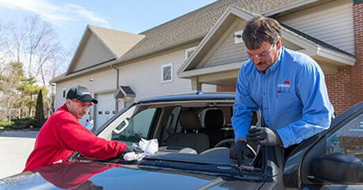 Portland Glass technician replacing car windshield.