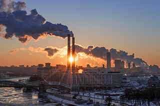 factories with plumes of smoke