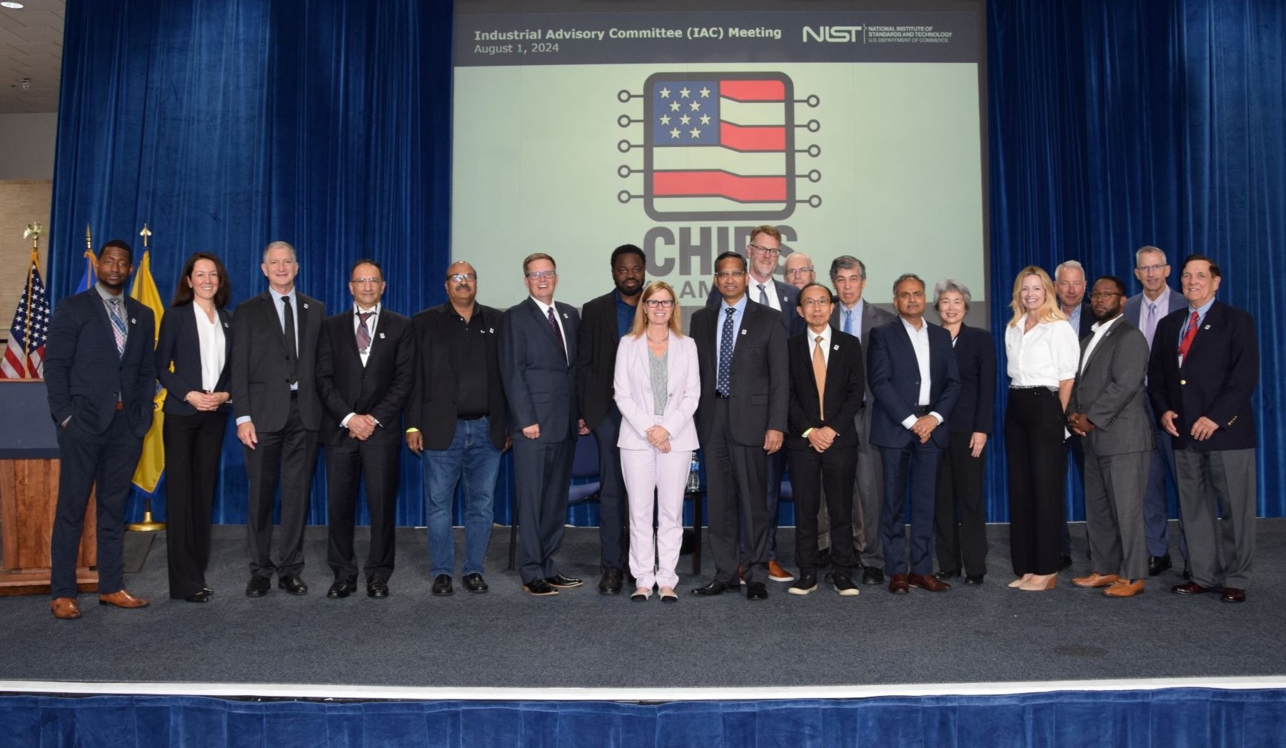 A photo of the Industrial Advisory Committee on a stage 