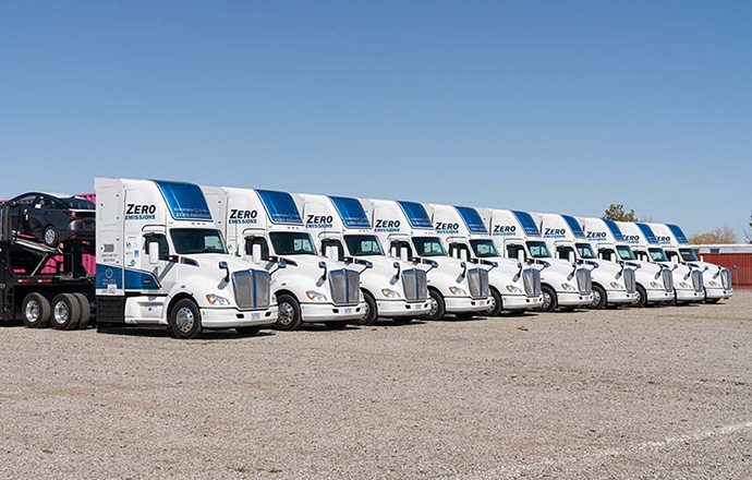 A fleet of zero-emissions trucks parked at a diagonal.