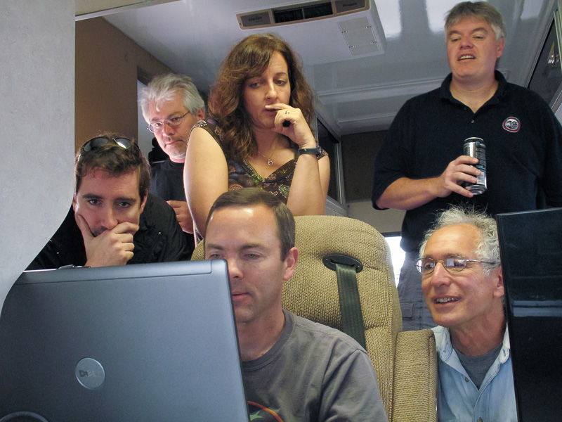 Researchers gathered around computer