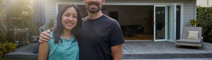 A couple standing in their backyard